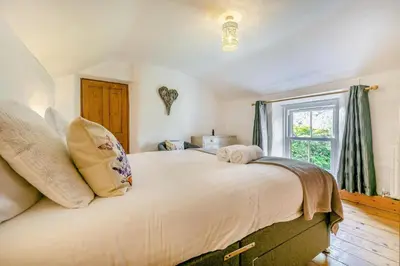 a large bed in a room with a window at 3 Bed in Cambrose oc-h29392 in Camborne