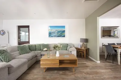 a living room with a couch and a table at Wheal Francis - Hot Tub - Accessible Bungalow - Free Wi-Fi - Parking in Helston