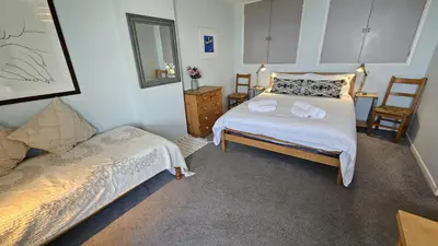 a bedroom with a bed with towels on it at Chywartha in Porthscatho