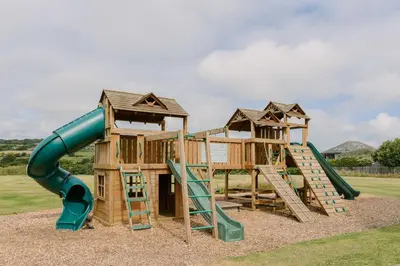 a playground with a slide and a slideintend at Wheal Rose - Hot Tub - Parking - Free WiFi - On-Site Activities in Helston