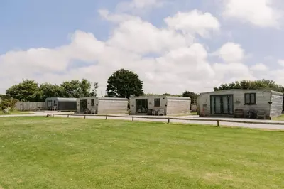 a group of three mobile homes in a field at Wheal Tor - Free WiFi - Parking - Pet Friendly - On-site Activities in Helston