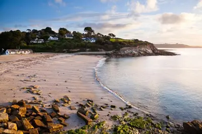 a beach with rocks in the water and houses at 2 Bed in Ponsanooth oc-f28845 in Ponsanooth