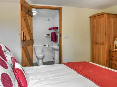 a bedroom with a bed and a bathroom with a toilet at Skiber Spar in Davidstow