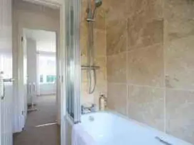a bathroom with a bath tub and a shower at Castaway, Port Isaac Bay Holidays in Port Isaac