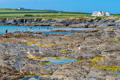 people swimming in the water on the rocks at the beach at 4 Bed in Padstow oc-s29537 in Padstow