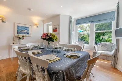 a dining room with a table and chairs at 5 Bed in Trebetherick oc-b29371 in Polzeath