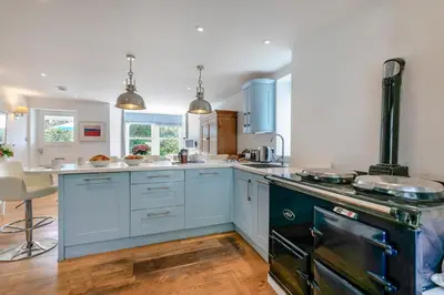 a kitchen with blue cabinets and a stove at 5 Bed in Trebetherick oc-b29371 in Polzeath