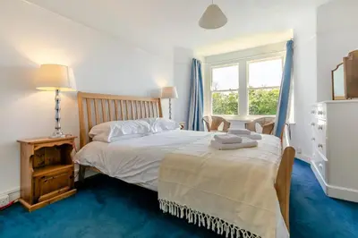 a bedroom with a bed and a window at 5 Bed in Trebetherick oc-b29371 in Polzeath