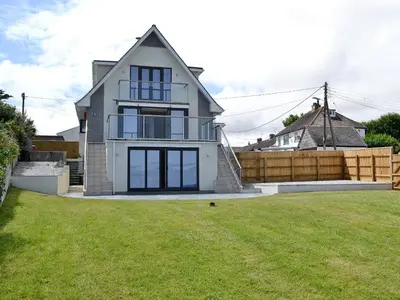 a house with a lawn in front of it at Sea Vista in Port Isaac