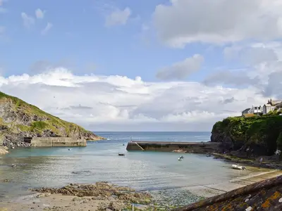 a beach with people swimming in the water at Sea Vista in Port Isaac