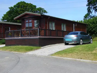 a house with a car parked in front of it at Rosewater Park Lodge in Bodmin