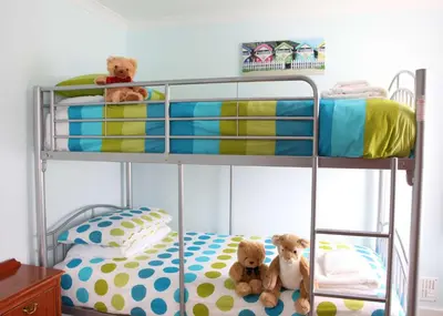 two teddy bears sitting on a bunk bed at Best Western Fowey Valley in Lostwithiel