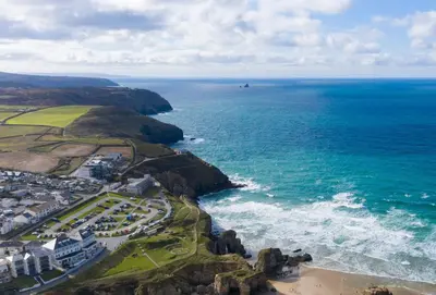 an aerial view of the ocean and a beach at The Wood Shed in Perranporth