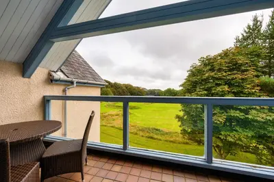 a view from the balcony of a house with a window at Golf View 80 in Camborne