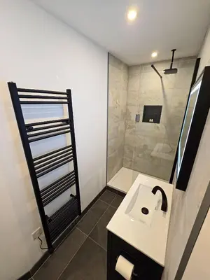 a bathroom with a sink and a shower at Premier 2 - Stunning Suite with Breathtaking Seaside Views in St Ives