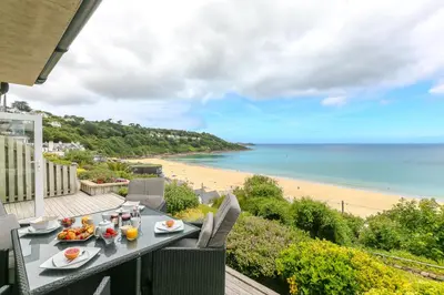a table with food and a view of the beach at Viridian in Carbis Bay