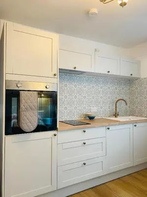 a kitchen with white cabinets and a sink at St Ives apartment less than 5 minutes walk to beach parking available in St Ives