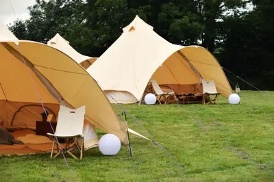 a group of tents sitting in the grass at Tylda Tents at Tregonetha Lake - 5m Luxury Bell Tent 