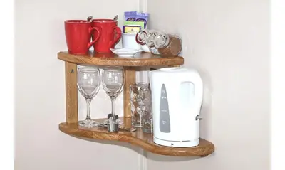 a wooden shelf with wine glasses and a toaster at Seven Bed and Breakfast in St. Agnes