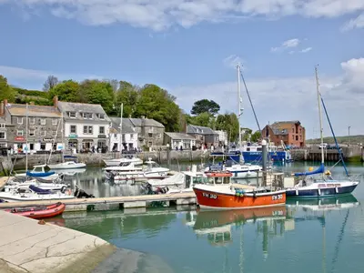a group of boats are docked in a harbor at April Cottage in Padstow