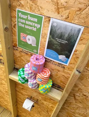 a shelf with pamphlets and signs on a wall at Lakeside Glamping Firecrest in Saint Columb Major