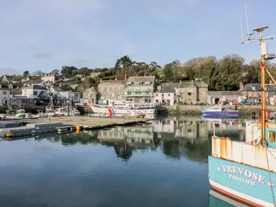 a boat docked at a dock in a harbor at Lowen Lodge in Padstow