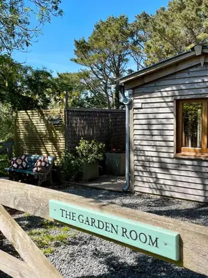 a sign that says the garden room in front of a cabin at The Garden Room - Cabin on The Lizard in Cury