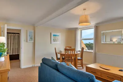 a living room with a blue couch and a table at Finest Retreats - No 11 Porthminster in St Ives