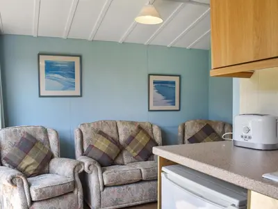 two chairs in a kitchen with blue walls at Old Town Cove - Uk47724 in St Merryn