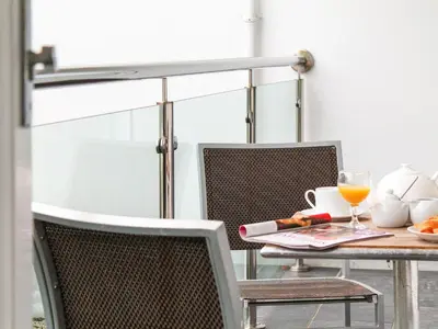 a table and chairs with a glass of orange juice at Sea Bleu in St Ives