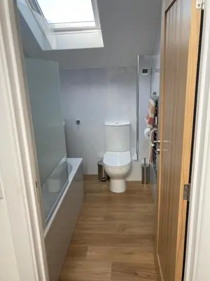 a bathroom with a toilet and a sink and a window at The Boathouse in Mylor Bridge