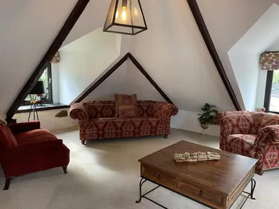 a living room with two couches and a coffee table at Stunning 4 Bed Pet Friendly Cottage with Hot Tub in Bodmin