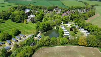 an aerial view of a park with a lake at 3 Bedroom lodge Hengar Manor sleeps 6 115 in Michaelstow