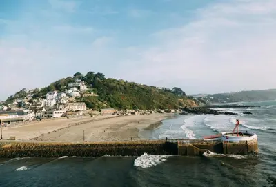 a view of a beach with a boat in the water at Hob Nob in Liskeard