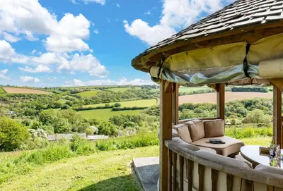 a gazebo with a view of the rolling hills at Blackberry Barn in Liskeard