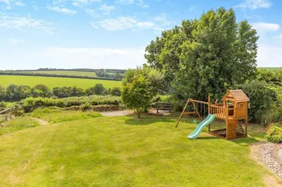 a playground in the garden of a house at 5 Bed in Bodmin oc-l29658 in Blisland