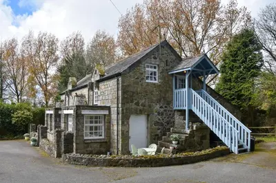 an old stone house with a staircase in front of it at 2 Bed in Trewoon oc-t29503 in St Austell