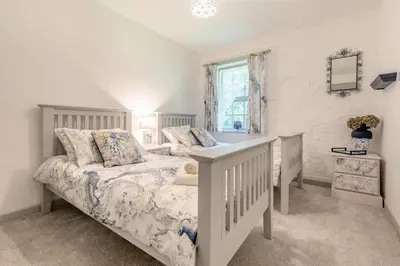 a white bedroom with a bed and a window at 2 Bed in Trewoon oc-t29503 in St Austell