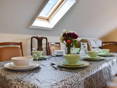 a table with plates and bowls and flowers on it at Lavrean Farm in St Austell