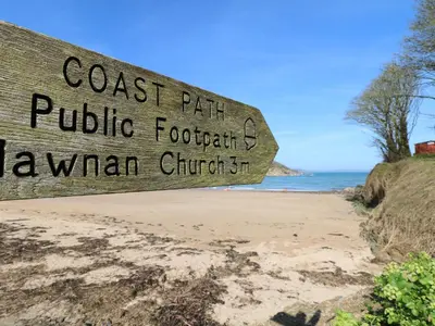 a sign for the coast path at the beach at 5 Tregenna Court in Falmouth