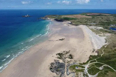 an aerial view of the beach and ocean at The Light House in Gwithian