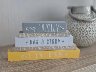 a stack of four books with the words every family has a story welcome to ours at Pool - Fireplace - 2Br Lodge - PetsOK - Parking in Newquay