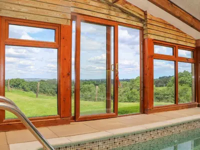 a room with a pool and windows with a view at Skiber Long in Callington