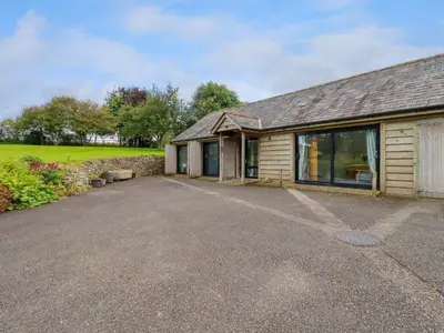 a house with a driveway in front of it at The Old Watermill in Bodmin