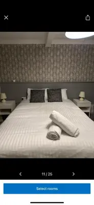 a bedroom with a large bed with white sheets and pillows at Kings head in Chacewater