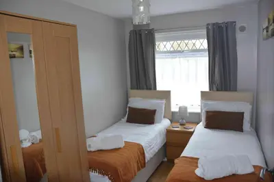 a small bedroom with two beds and a window at Itldo in Truro