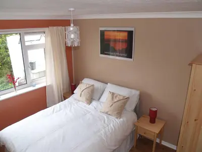a bedroom with a white bed and a window at Itldo in Truro