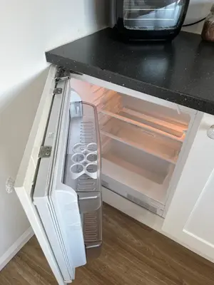 an open refrigerator with its door open in a kitchen at Hellfire corner in Redruth