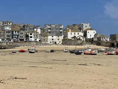 a group of boats sitting on the sand on a beach at 1 Sunnyside - views over the St Ives Harbour in St Ives