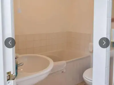 a bathroom with a tub and a toilet at The Cove, Portreath in Portreath